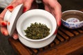 Woman holding chawan with green oolong.