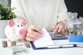 Woman holding checks for purchases in hand and counting on calculator closeup Royalty Free Stock Photo