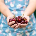 Woman holding cherries