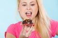 Woman holding chocolate cupcake about to bite Royalty Free Stock Photo