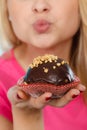 Woman holding chocolate cupcake about to bite Royalty Free Stock Photo