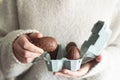 Woman holding a chocolate egg from egg carton Royalty Free Stock Photo