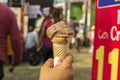 An woman holding a chocolate Turkish ice cream cone at a food festival. Selective focus