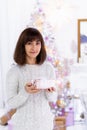 Woman holding Christmas gift box in her hands. Young adult with present box Royalty Free Stock Photo