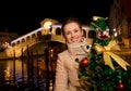 Woman holding Christmas tree near Rialto Bridge in Venice, Italy Royalty Free Stock Photo