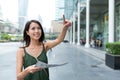 Woman holding city map and finger pointing far away in Bangkok c