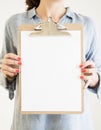 woman holding clipboard with white paper