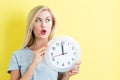 Woman holding clock showing nearly 12 Royalty Free Stock Photo