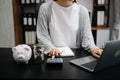 Caucasian Women are putting coins in a piggy bank for a business that grows for profit and saving money for the future. planning Royalty Free Stock Photo