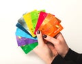 Woman holding collection of colourful credit cards