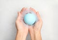 Woman holding color bath bomb over foam