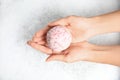 Woman holding color bath bomb over foam Royalty Free Stock Photo