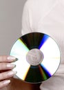 Woman holding a compact disc. Conceptual image shot Royalty Free Stock Photo