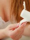 Woman holding cotton swab and makeup remover in hands Royalty Free Stock Photo