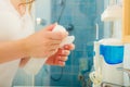 Woman holding cotton swab and makeup remover in hands Royalty Free Stock Photo