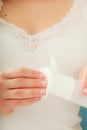 Woman holding cotton swab and makeup remover in hands Royalty Free Stock Photo