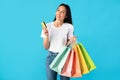 Woman holding credit card and carrying shopping bags Royalty Free Stock Photo