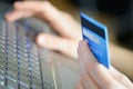 Woman holding credit card on laptop for online shopping concept