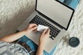 Woman holding credit card for online shopping, Payment, and working on a laptop Female using a laptop sitting on floor, Royalty Free Stock Photo