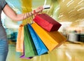 Woman holding credit card and shopping bags