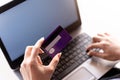 Woman holding credit card and typing on the keyboard of laptop with Shopping cart, online shopping, online payment Royalty Free Stock Photo