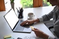 Woman holding credit card and using internet banking service on laptop computer. Royalty Free Stock Photo