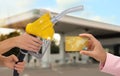 Woman holding credit card and worker with fuel nozzle at gas station, closeup. Cashless payment Royalty Free Stock Photo