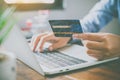 Woman holding credit cards and mobile phones are now shopping over the internet by paying by credit card