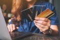A woman holding credit cards while using laptop Royalty Free Stock Photo