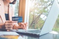 Woman holding credit cards and using laptops shopping online Royalty Free Stock Photo