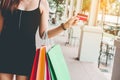 Woman holding credit crad enjoying shopping street Royalty Free Stock Photo