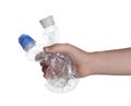 Woman holding crumpled bottles on background, closeup. Plastic recycling