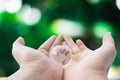 Woman holding crystal earth ball with natural background Royalty Free Stock Photo