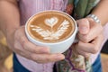 Woman holding cup of coffee, close up.