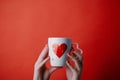 Woman holding cup with heart shape. Close up Royalty Free Stock Photo