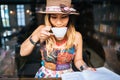 Woman is holding a cup of hot cappuccino and reading a book, Business woman read a book in coffee