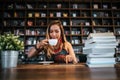 Woman is holding a cup of hot cappuccino and reading a book, Business woman read a book