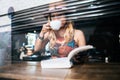 Woman is holding a cup of hot cappuccino and reading a book, Business woman read a book