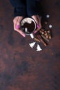 Woman holding cup of hot chocolate.