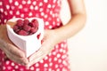 Woman holding a cup of raspberries Royalty Free Stock Photo