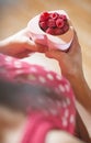 Woman holding a cup of raspberries Royalty Free Stock Photo