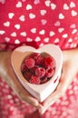 Woman holding a cup of raspberries Royalty Free Stock Photo