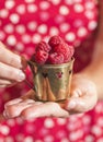 Woman holding a cup of raspberries Royalty Free Stock Photo