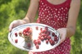 Woman holding a cup of raspberries Royalty Free Stock Photo