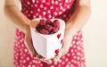 Woman holding a cup of raspberries Royalty Free Stock Photo