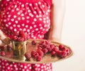 Woman holding a cup of raspberries Royalty Free Stock Photo