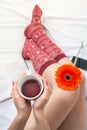 Woman holding a cup of tea in bed Royalty Free Stock Photo