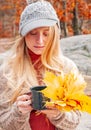 Woman holding cup of tea in the hands outdoor in autumn park Royalty Free Stock Photo