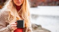 Woman holding cup of tea in the hands outdoor in autumn park Royalty Free Stock Photo