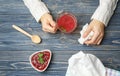 Woman holding cup of tea with raspberry jam Royalty Free Stock Photo